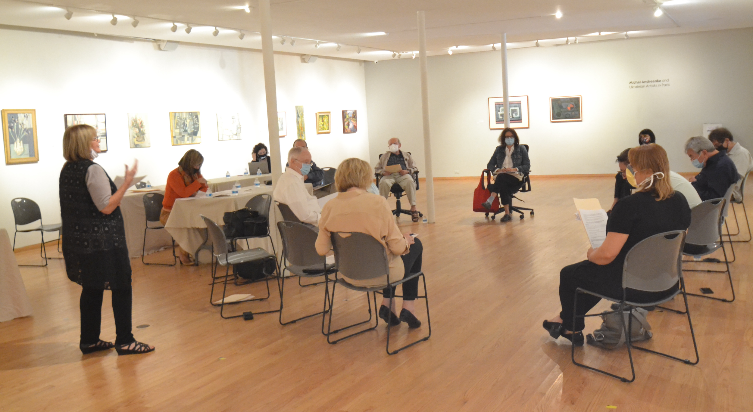 UIMA board members meeting in the gallery, surrounded by works from the Michel Andreenko exhibition