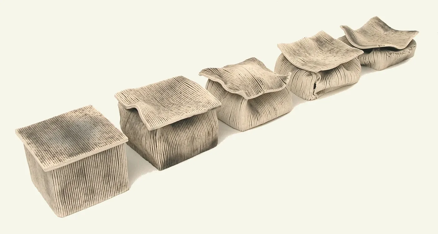 A row of five ridged ceramic vessel sculptures resembling folded cloth, arranged from small and closed to large and open