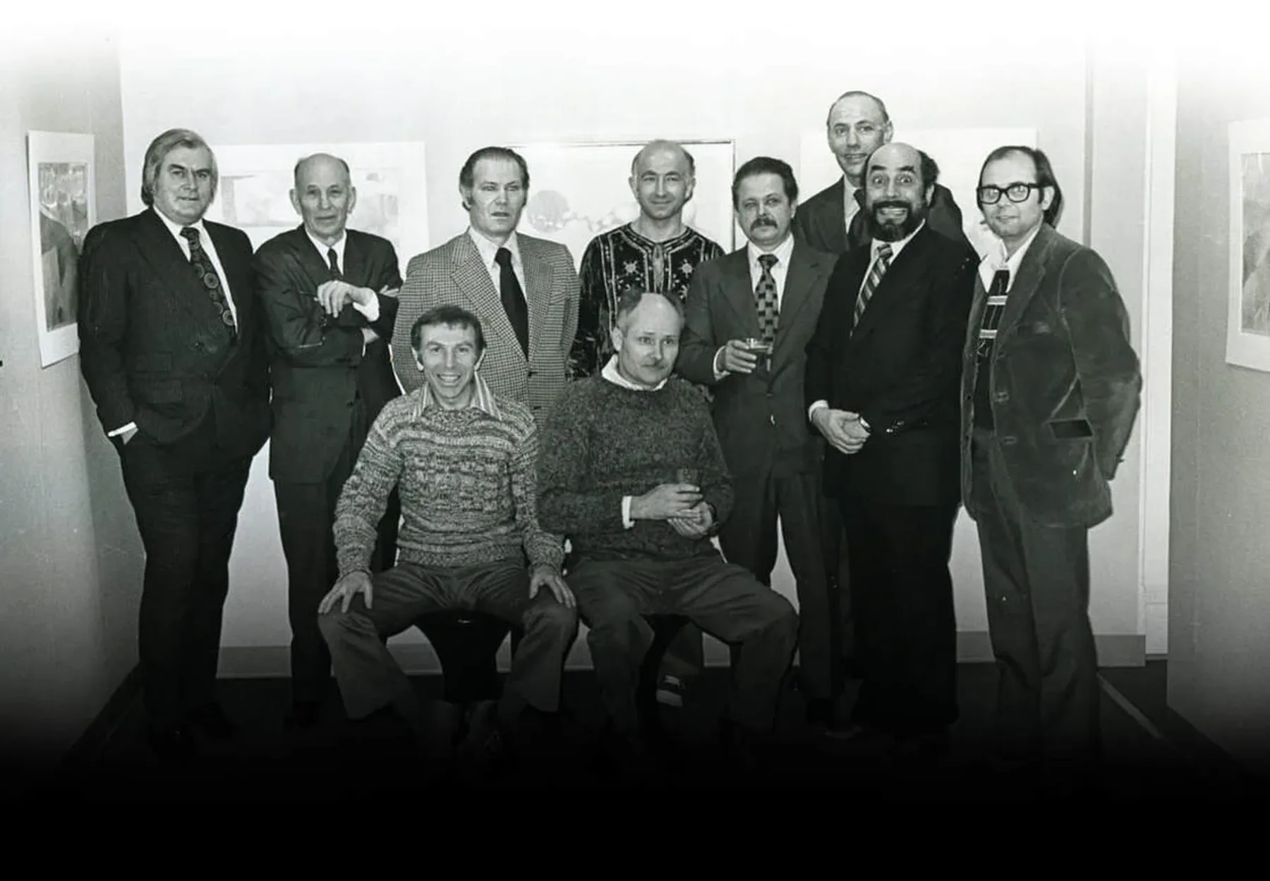 Archival black-and-white photograph of UIMA's founders and early supporters gathered at a gallery opening